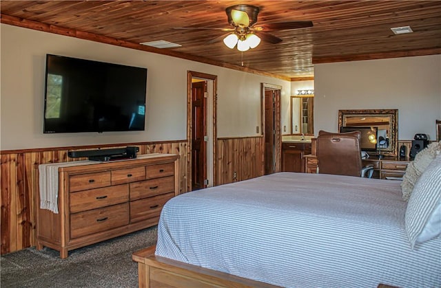 bedroom with ensuite bathroom, carpet flooring, wooden ceiling, and ceiling fan