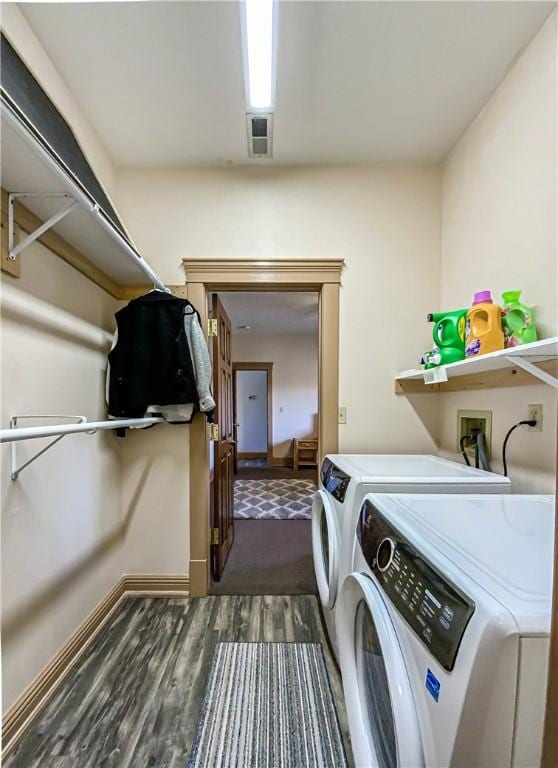 washroom with dark hardwood / wood-style flooring and independent washer and dryer