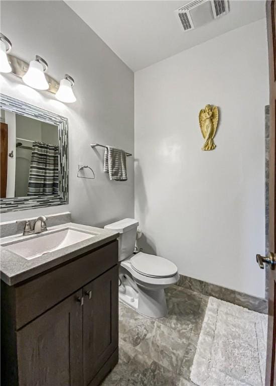 bathroom featuring vanity, a shower with shower curtain, and toilet