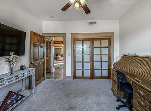 office featuring ceiling fan and dark carpet