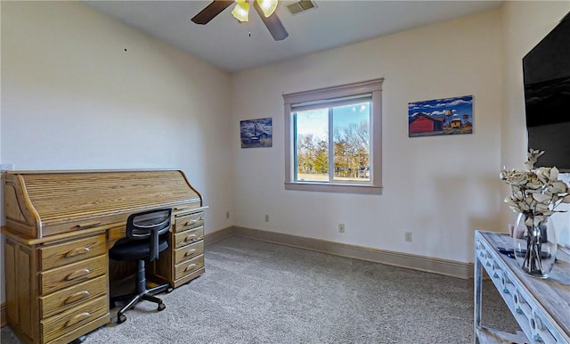 carpeted office space featuring ceiling fan