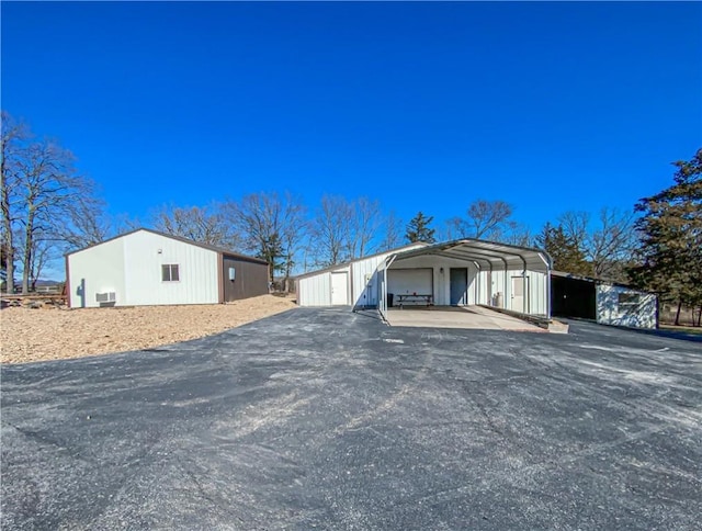 view of side of home with an outbuilding and a carport