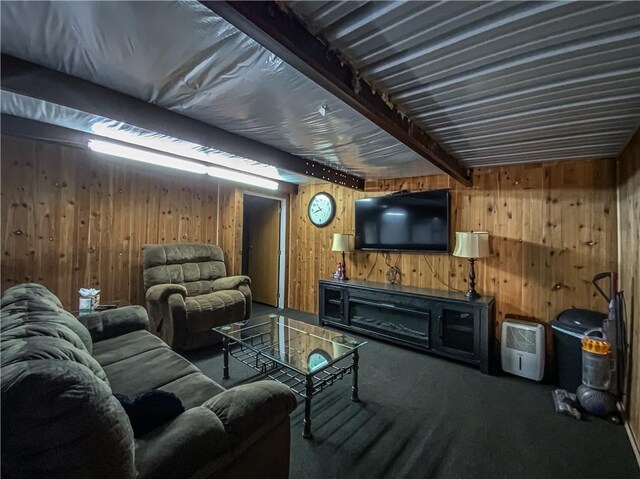 living room featuring beam ceiling and wood walls