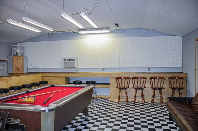 recreation room with billiards, vaulted ceiling, a wall unit AC, and bar area