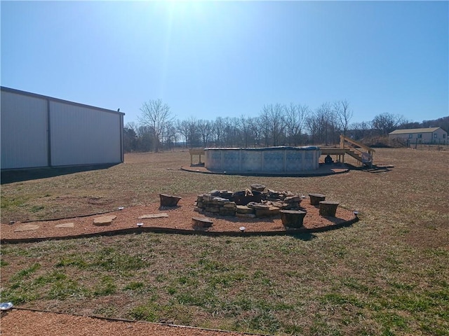 view of yard with a fire pit