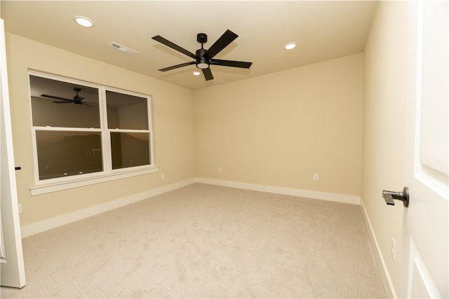 empty room featuring ceiling fan and light colored carpet