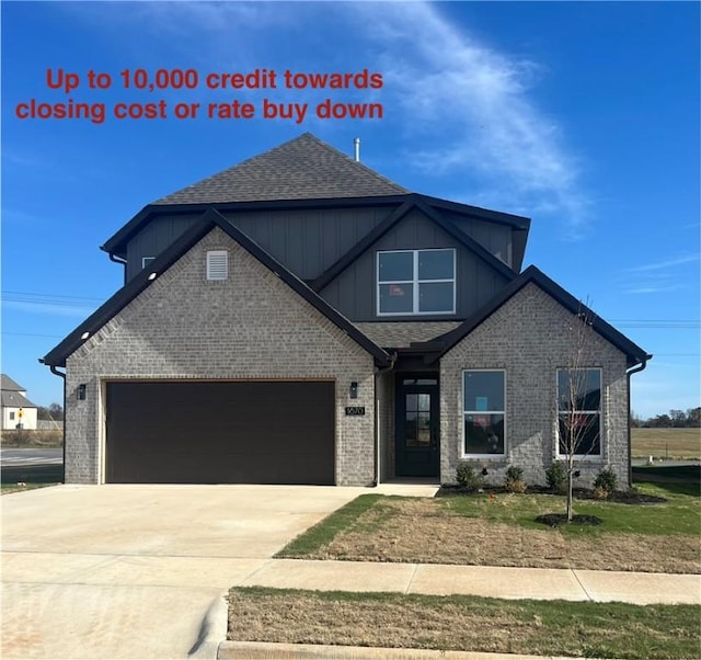 view of front of house featuring brick siding, an attached garage, driveway, and board and batten siding