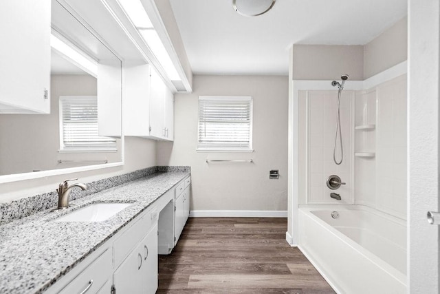 bathroom with shower / washtub combination, hardwood / wood-style floors, plenty of natural light, and vanity