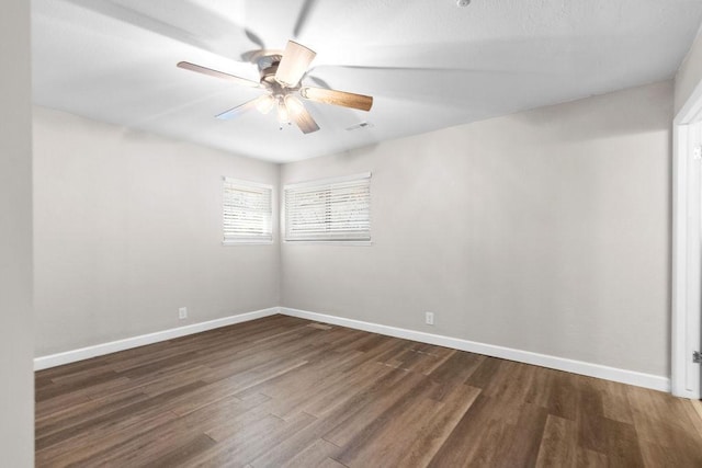 spare room featuring ceiling fan and dark hardwood / wood-style floors