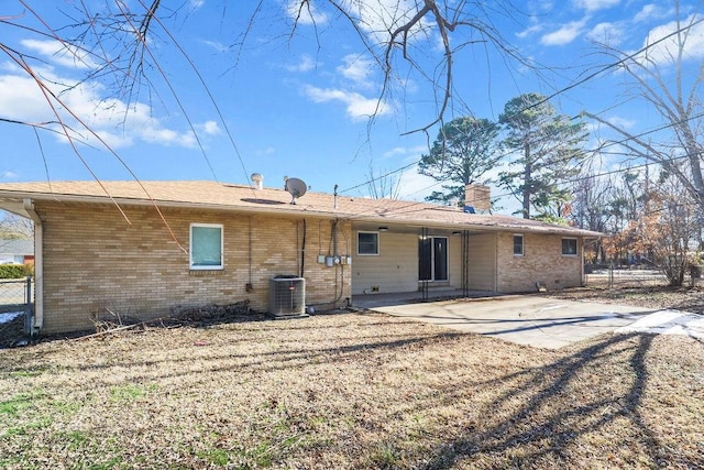 rear view of house featuring central air condition unit and a patio