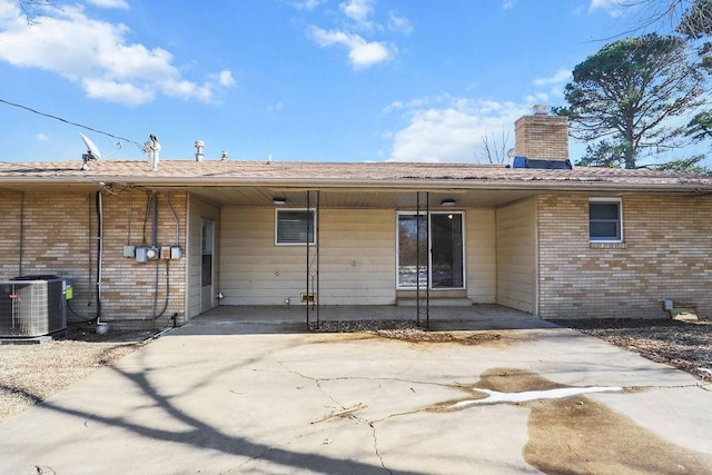 rear view of property featuring central AC