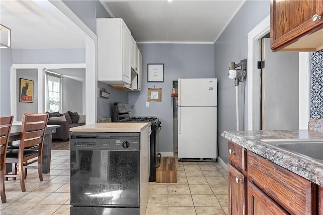 kitchen featuring white cabinetry, black dishwasher, white fridge, light tile patterned floors, and stove