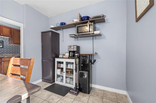 kitchen featuring light tile patterned floors and decorative backsplash