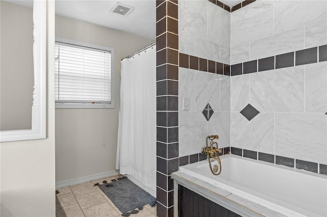 bathroom featuring shower / bath combo and tile patterned flooring