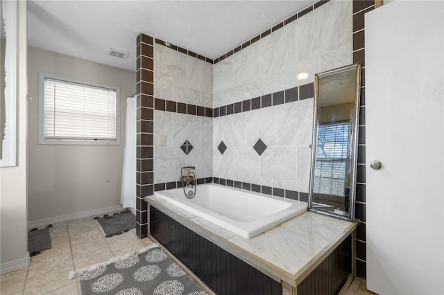 bathroom with washtub / shower combination and tile patterned flooring