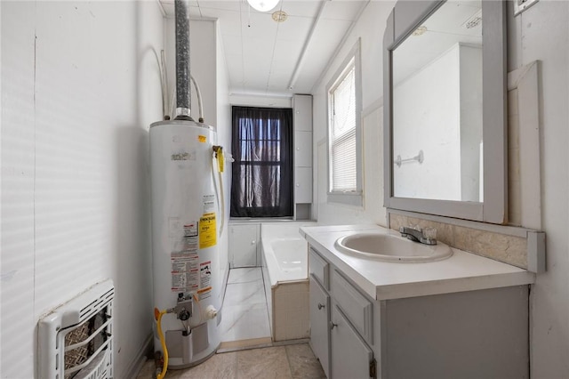 bathroom with a washtub, water heater, heating unit, and vanity