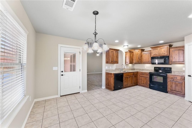 kitchen featuring pendant lighting, sink, light tile patterned floors, black appliances, and an inviting chandelier