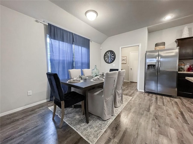 dining area with hardwood / wood-style floors and lofted ceiling