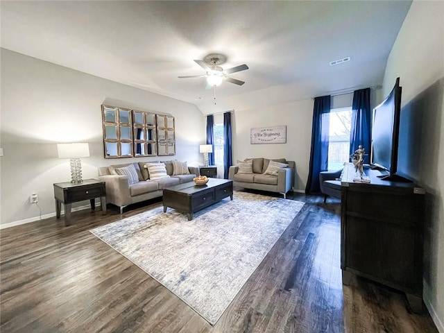 living room featuring dark hardwood / wood-style floors and ceiling fan