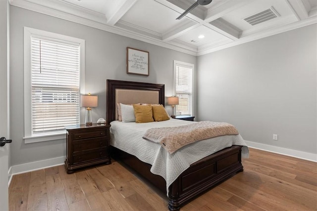 bedroom featuring coffered ceiling, beamed ceiling, ceiling fan, and ornamental molding