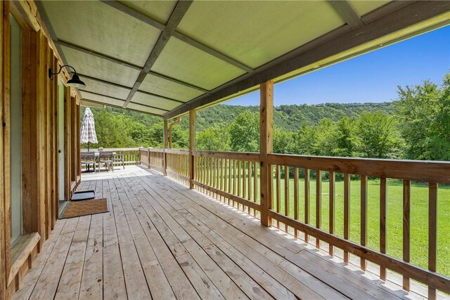 wooden terrace with a lawn