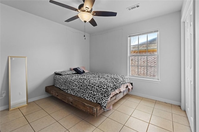 tiled bedroom with ceiling fan