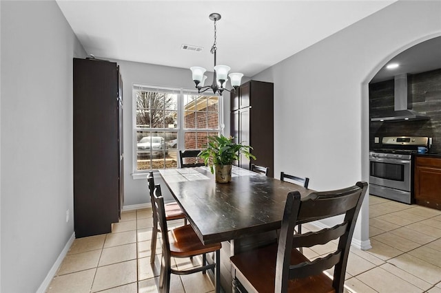 dining space featuring an inviting chandelier and light tile patterned floors