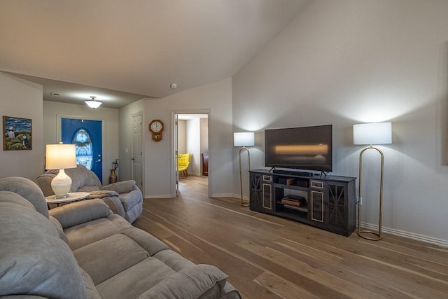 living room with hardwood / wood-style flooring and lofted ceiling