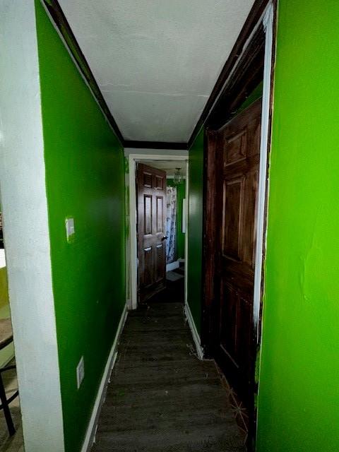 corridor with dark hardwood / wood-style flooring and a textured ceiling