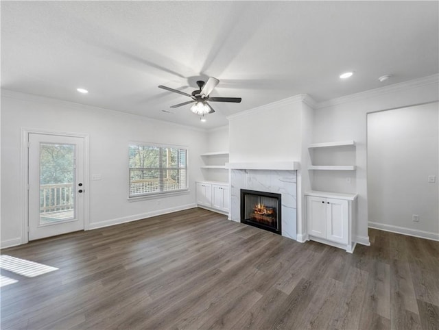 unfurnished living room featuring dark hardwood / wood-style flooring, crown molding, and a high end fireplace