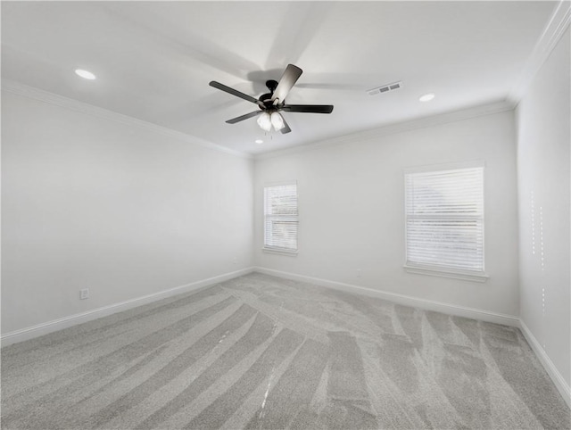 carpeted spare room featuring crown molding and ceiling fan