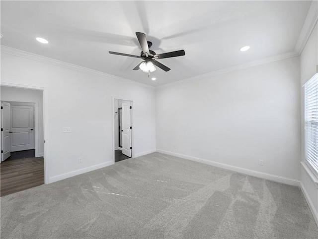 carpeted empty room with crown molding and ceiling fan