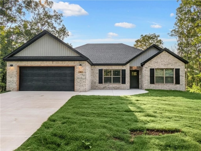 view of front facade with a garage and a front lawn