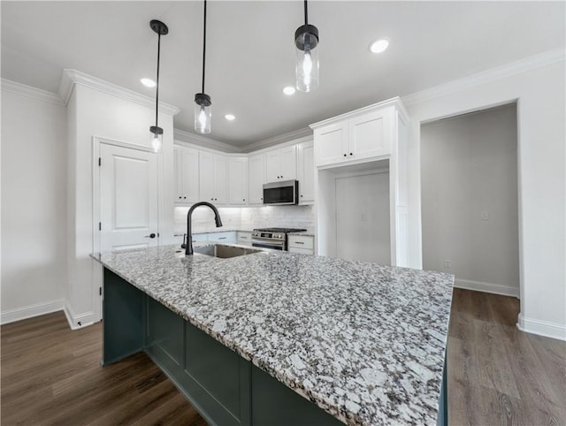 kitchen with white cabinetry, appliances with stainless steel finishes, sink, and light stone counters