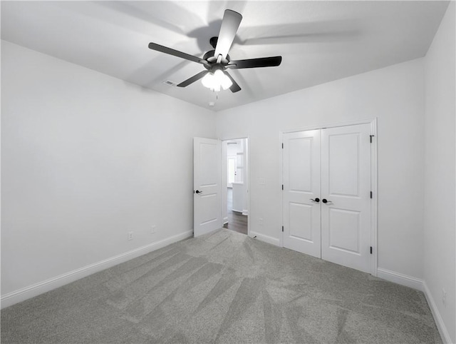 unfurnished bedroom with carpet, ceiling fan, and a closet