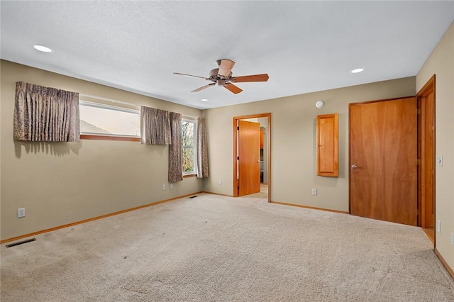 carpeted empty room with ceiling fan