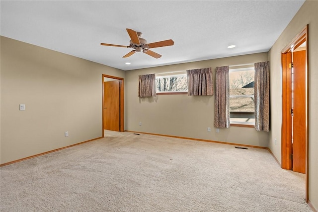 unfurnished bedroom featuring ceiling fan and light colored carpet