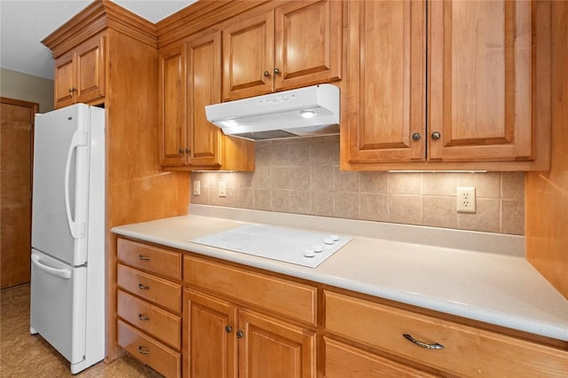 kitchen with backsplash and white appliances