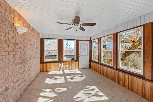 unfurnished sunroom with ceiling fan