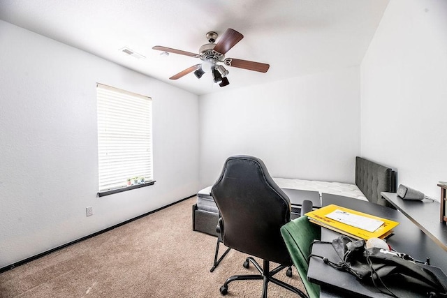 office space featuring light carpet and ceiling fan