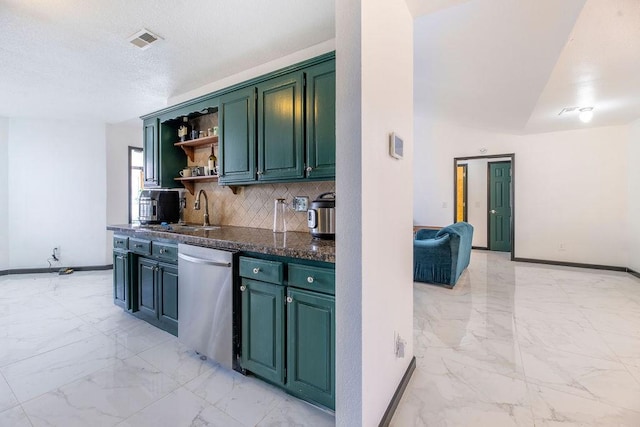 kitchen with green cabinets, sink, stainless steel dishwasher, and backsplash