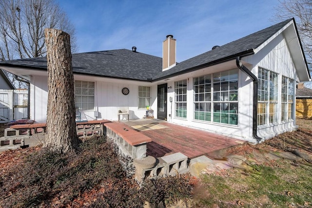 back of property with a wooden deck