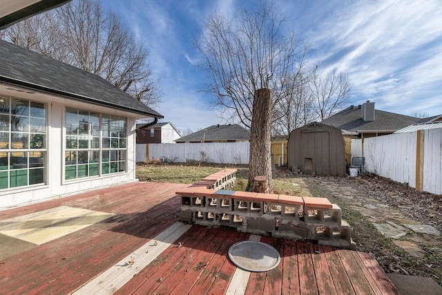 wooden deck featuring a storage unit