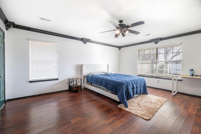 bedroom with dark hardwood / wood-style flooring, ornamental molding, and ceiling fan