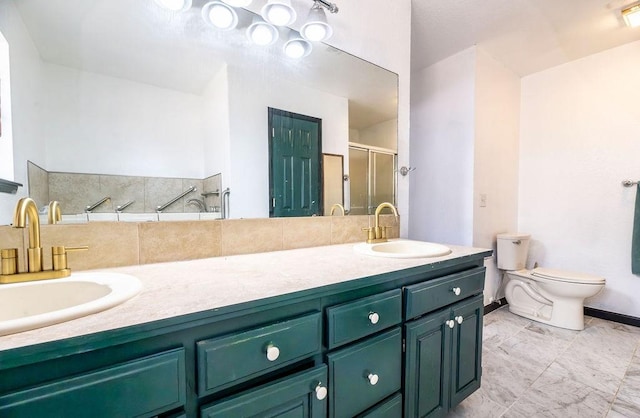 bathroom with vanity, a shower with shower door, and toilet