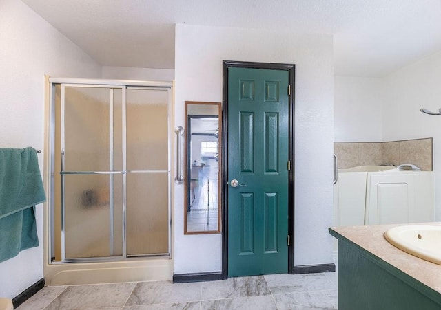 bathroom featuring vanity and a shower with door