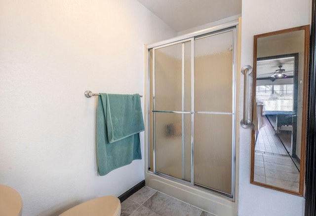 bathroom with an enclosed shower, tile patterned floors, and toilet