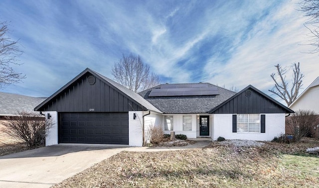 view of front of house featuring a garage and solar panels