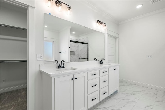 full bath with a sink, a marble finish shower, marble finish floor, and crown molding