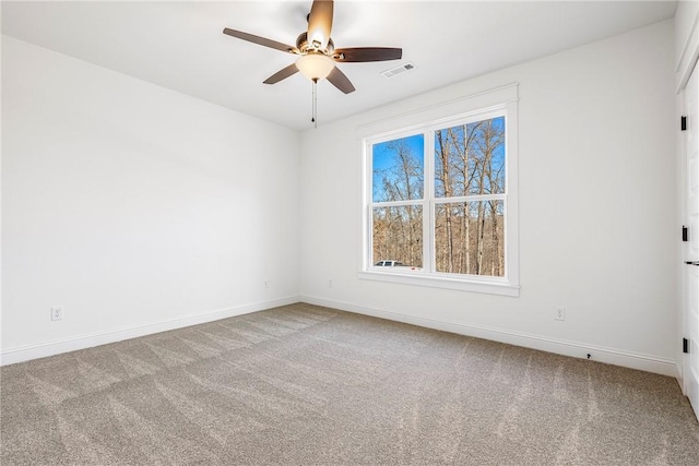 spare room with visible vents, baseboards, a ceiling fan, and carpet flooring